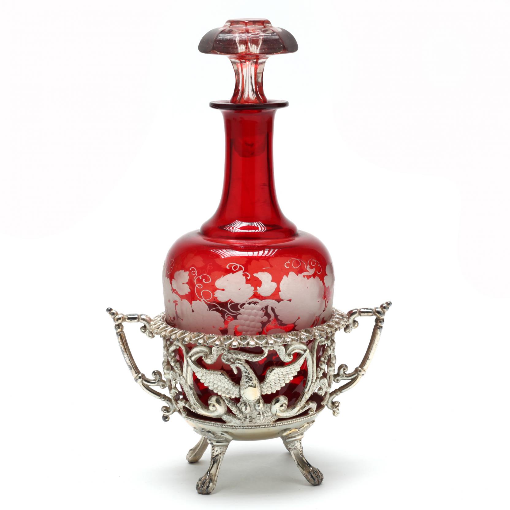 an-antique-ruby-glass-decanter-in-silverplate-bottle-stand