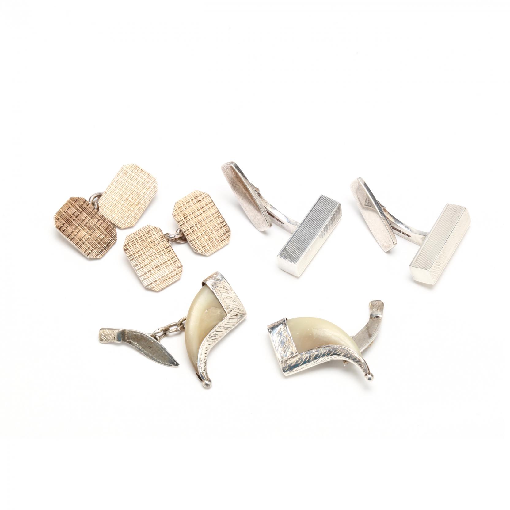 three-pairs-of-silver-cufflinks