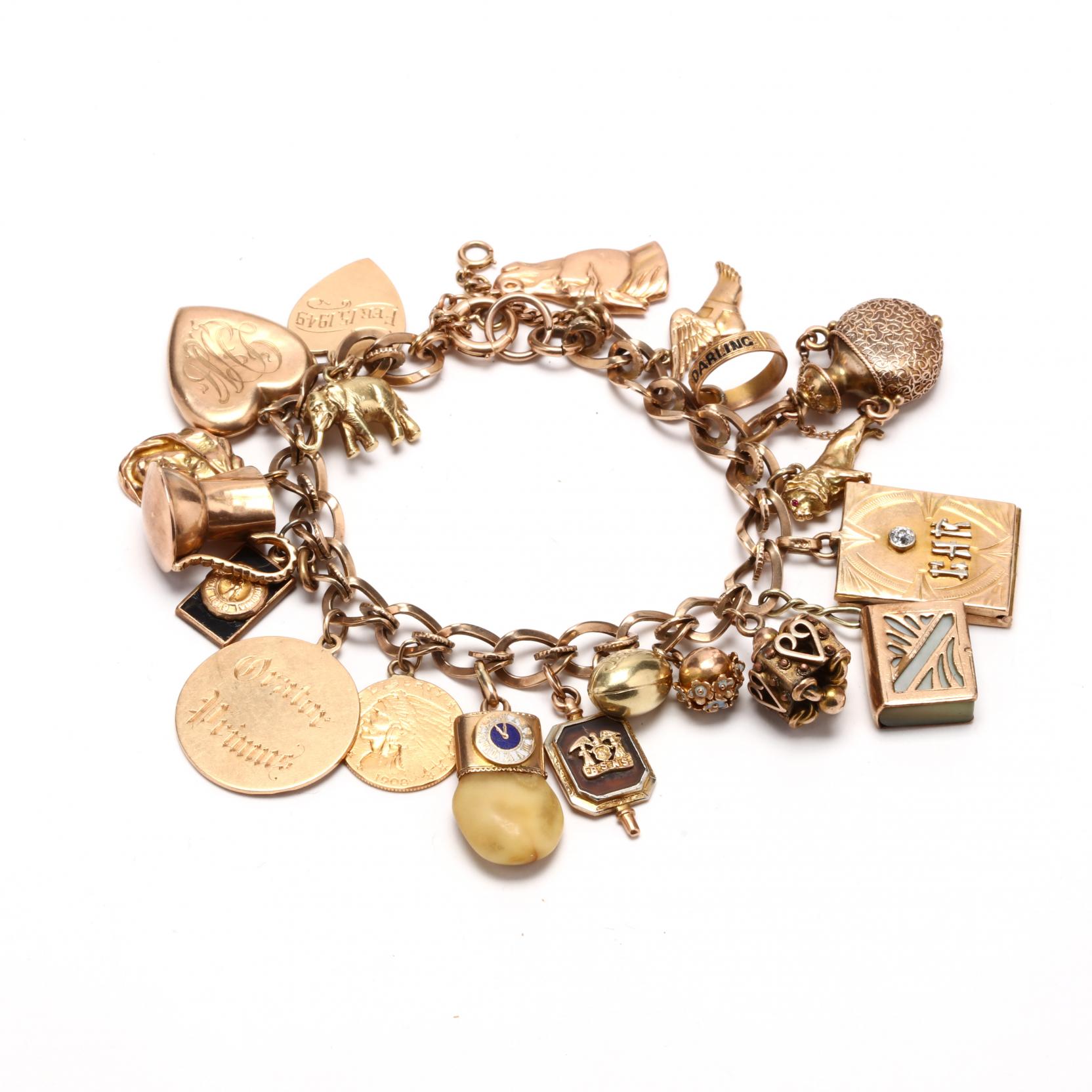 Lot: 1219: Tiffany gold charm bracelet,, Lot Number: 1219, Starting Bid:  $600, Auctioneer: Brunk Auctions, Auc…