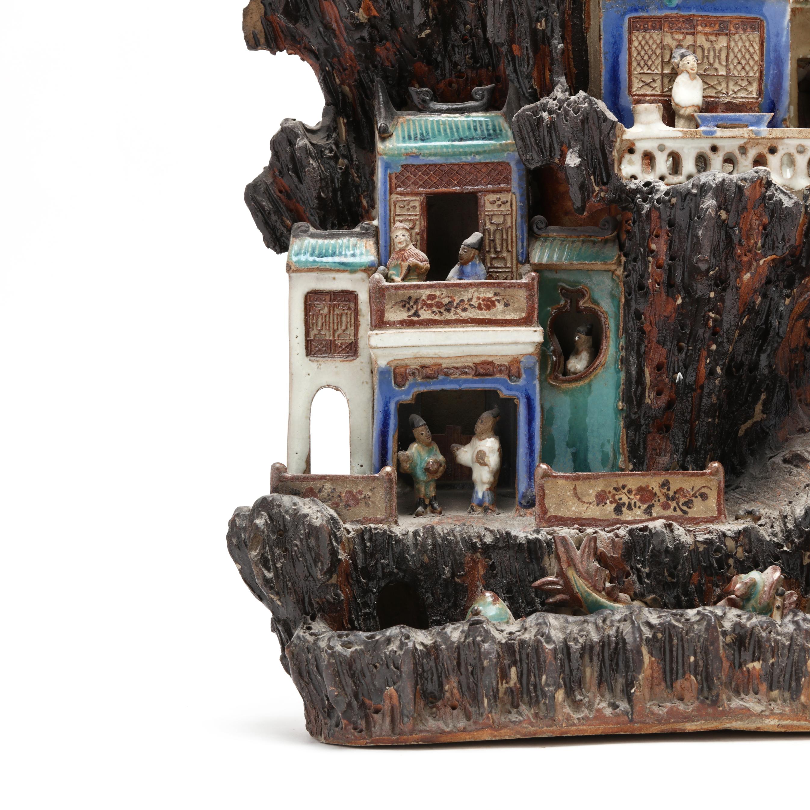 A Chinese Shiwan Glazed Pottery Mountain with Figures and