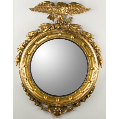 a-carved-and-gilded-bull-s-eye-mirrror