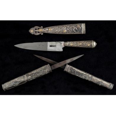 two-silver-sheathed-knives
