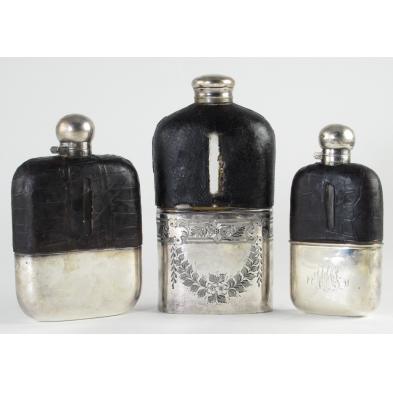 three-vintage-silver-and-leather-flasks
