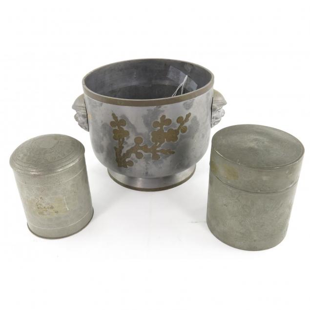 three-asian-white-metal-objects