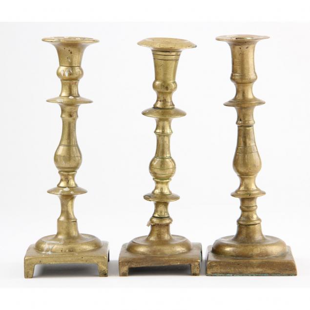 three-antique-brass-candlesticks