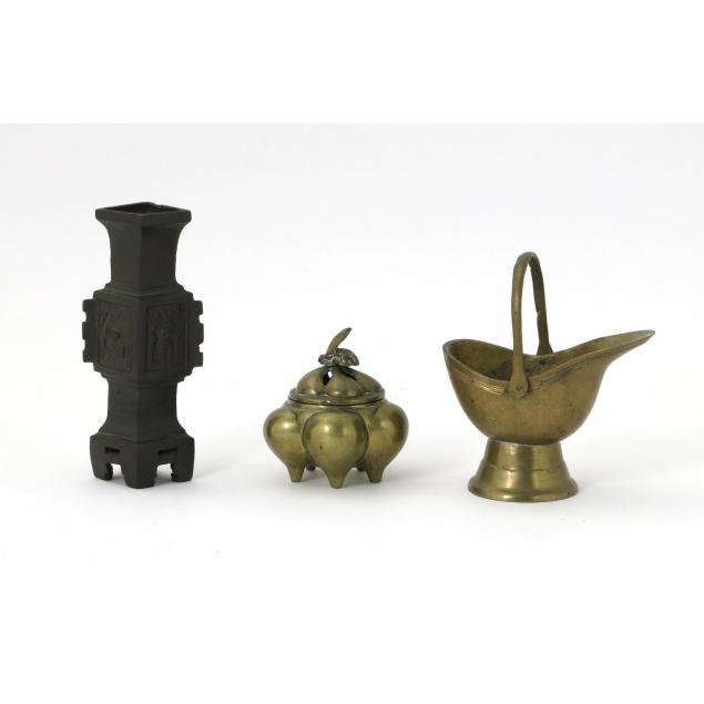 three-chinese-metal-objects