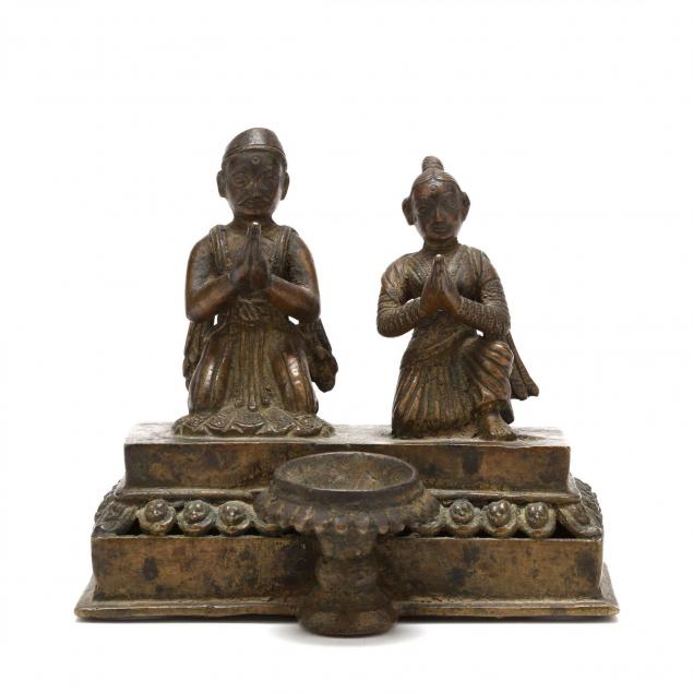nepalese-ritual-lamp-with-couple-praying