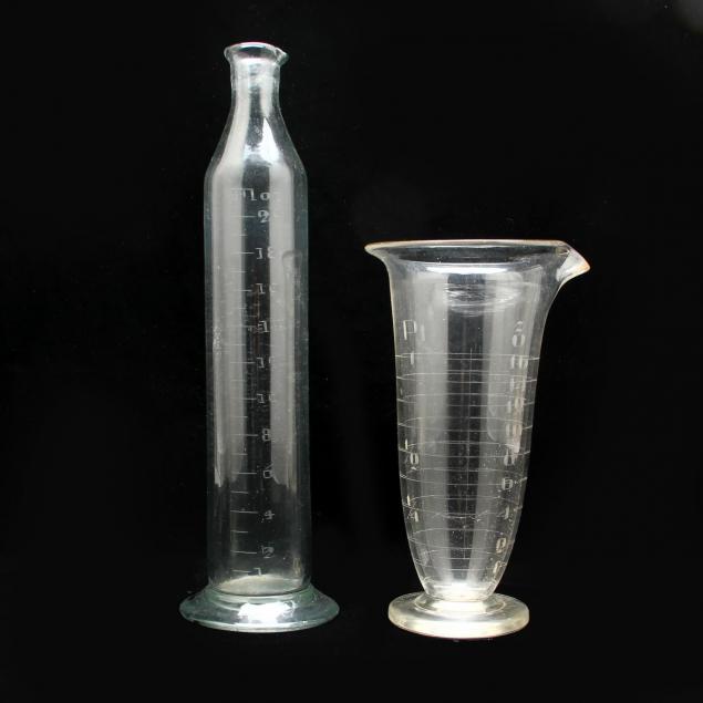 two-antique-pharmaceutical-graduated-glass-measures