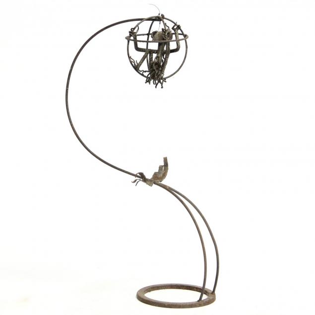 industrial-found-object-outdoor-sculpture-with-creature-in-cage