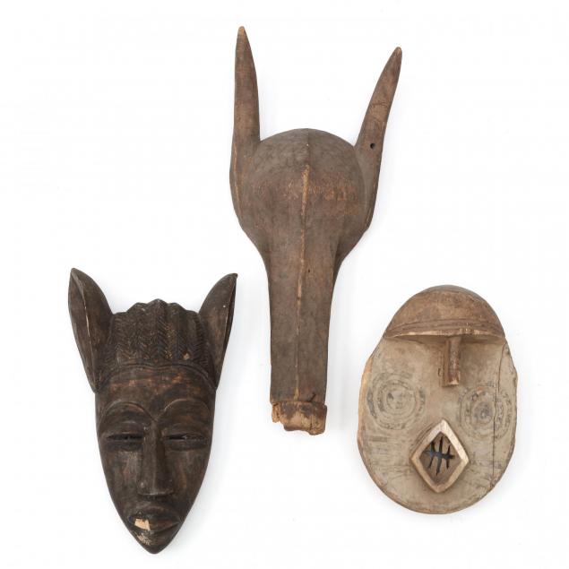 two-west-african-carved-wooden-masks-and-a-headdress