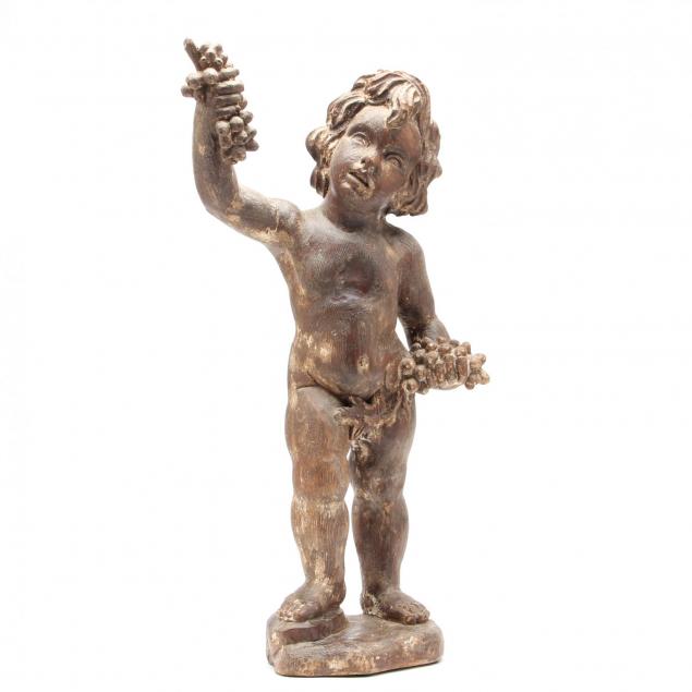 a-continental-carved-wood-putto-with-grapes
