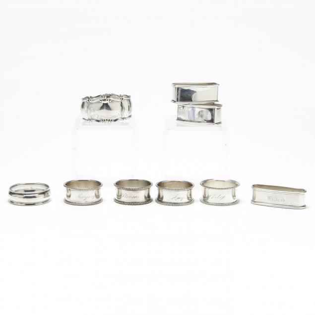 an-assembled-set-of-nine-sterling-silver-napkin-rings