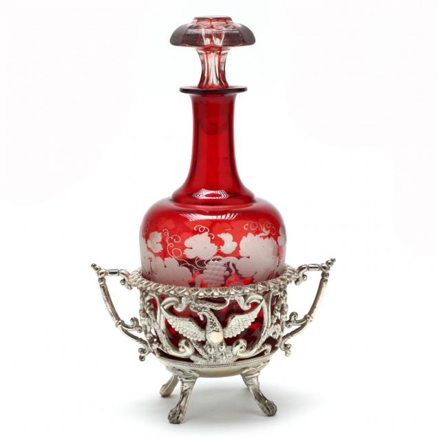 an-antique-ruby-glass-decanter-in-silverplate-bottle-stand