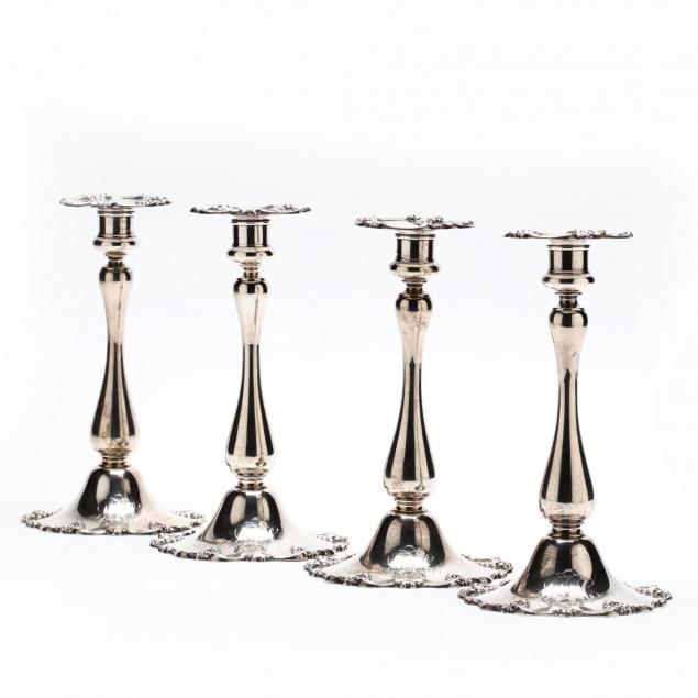a-set-of-four-sterling-silver-candlesticks
