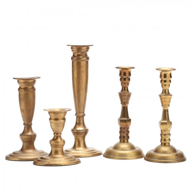 assembled-group-of-brass-candlesticks