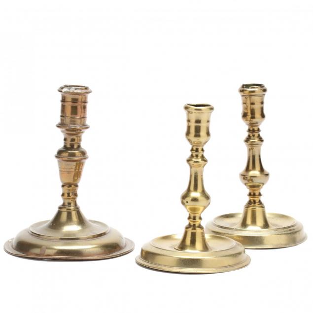 three-antique-brass-candlesticks