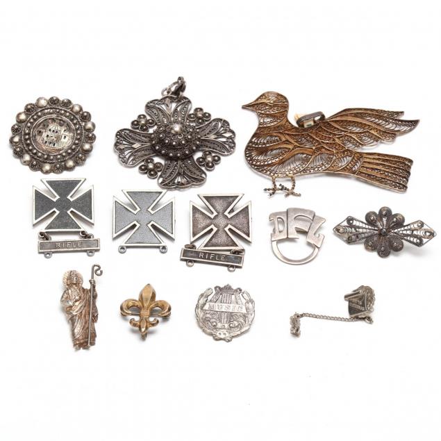 group-of-silver-brooches-and-pendants