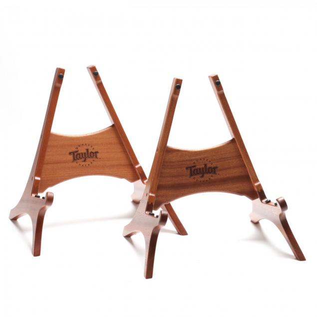 two-taylor-acoustic-guitar-wooden-stands