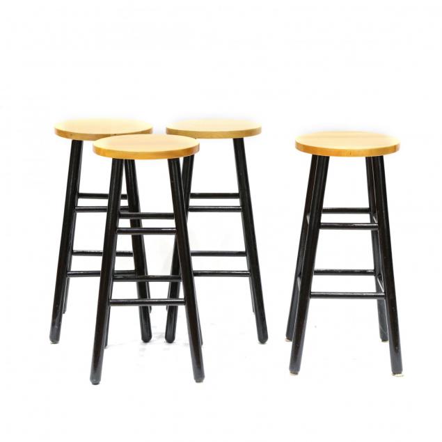 a-set-of-four-wooden-bar-stools