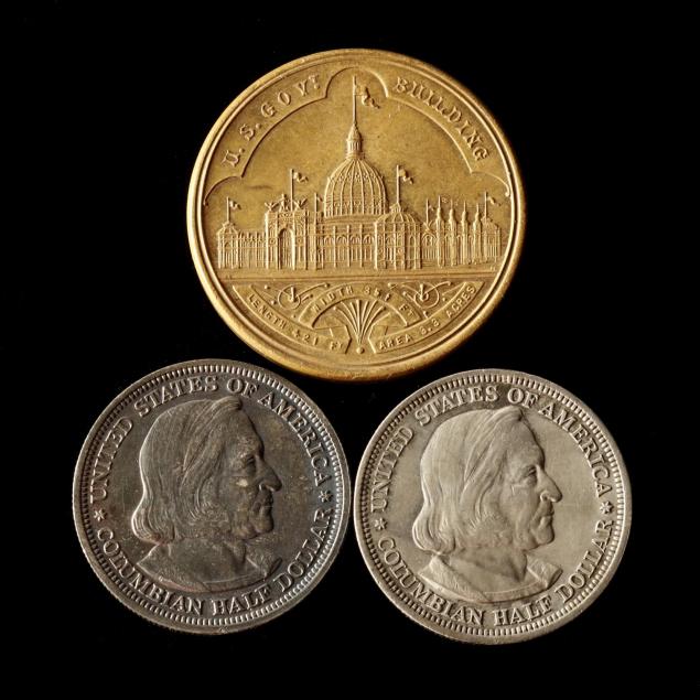 two-columbian-half-dollars-and-a-related-medallion