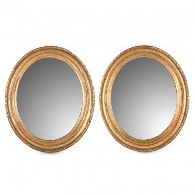 a-pair-of-antique-framed-oval-looking-glasses