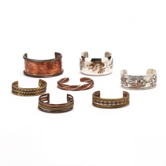 a-group-of-mixed-metal-cuff-bracelets