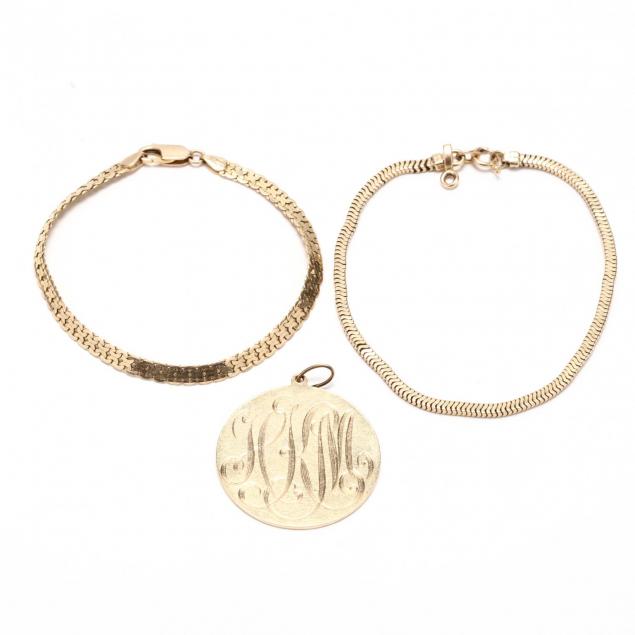 two-gold-bracelets-and-a-gold-charm