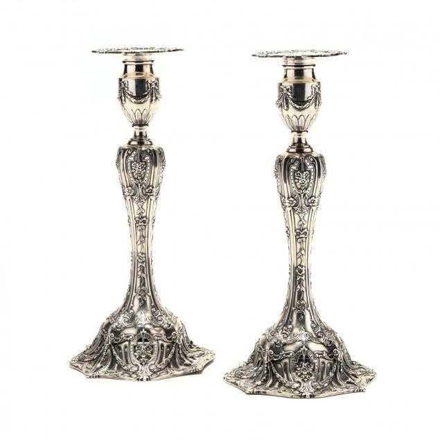 a-pair-of-cast-sterling-silver-candlesticks