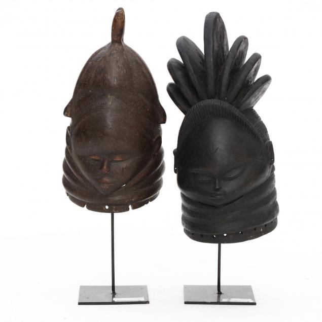 two-mende-sierra-leone-carved-wood-helmet-masks-on-stands