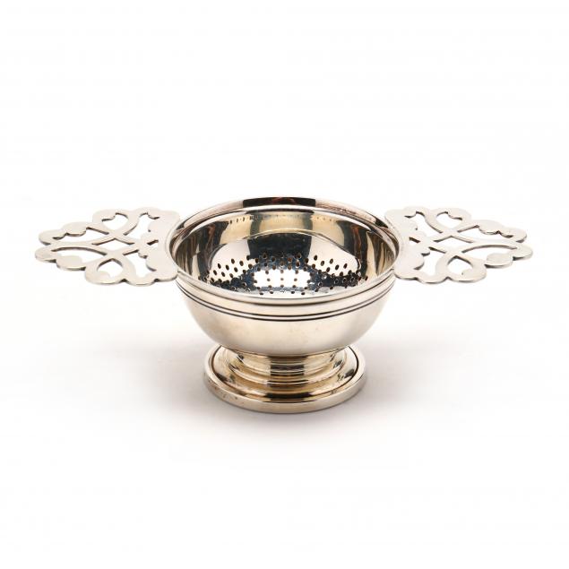 an-elizabeth-ii-silver-tea-strainer-with-stand