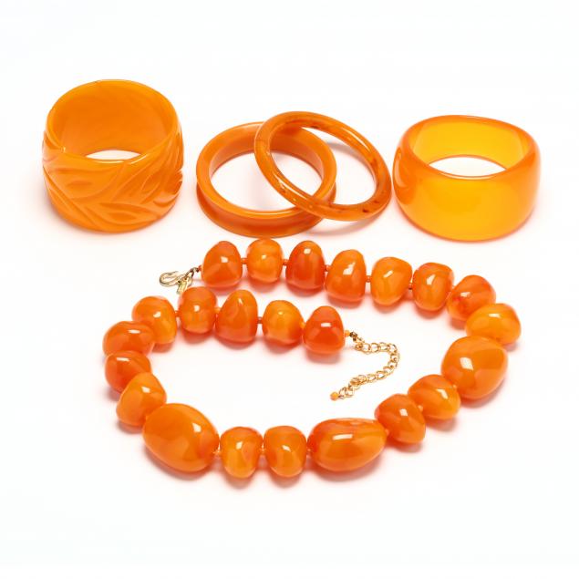 group-of-orange-plastic-bangles-and-a-kenneth-lane-necklace