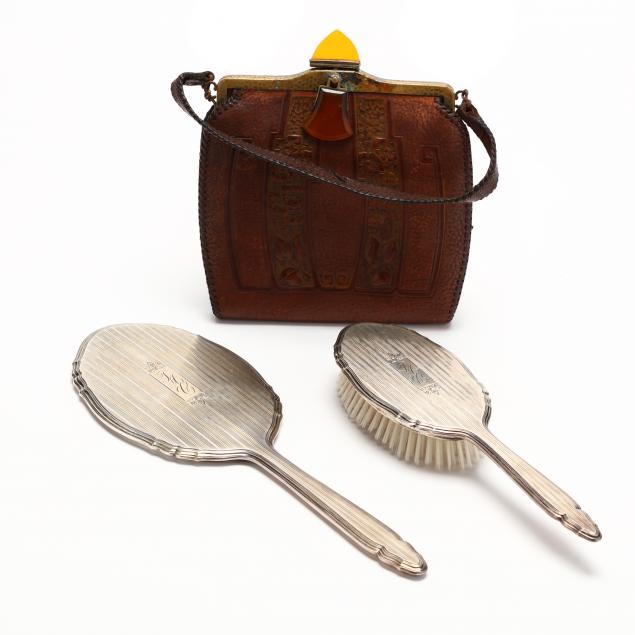 an-arts-crafts-tooled-leather-purse-and-a-sterling-silver-vanity-set