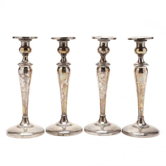 a-set-of-four-sterling-silver-candlesticks