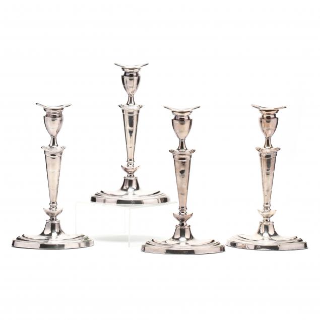 a-set-of-four-neoclassical-style-silverplate-candlesticks