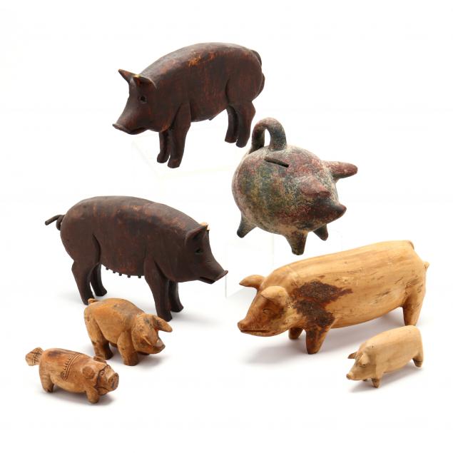 a-collection-of-seven-pig-sculptures
