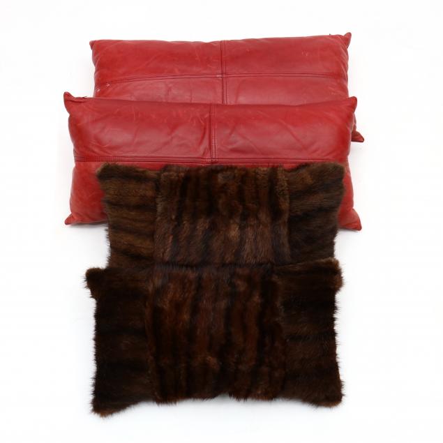 a-pair-of-red-leather-pillows-and-mink-covered-pillows