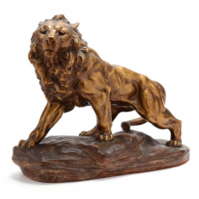 a-gilt-plaster-sculpture-of-a-prowling-lion