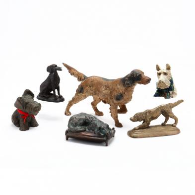 group-of-metal-dog-doorstops-and-banks
