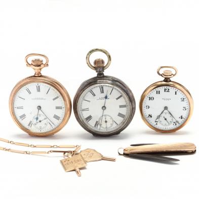 three-vintage-open-face-pocket-watches-with-gold-chain-and-fobs