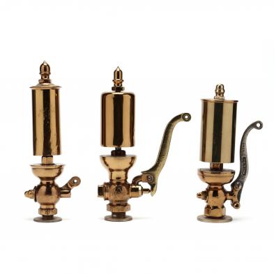 three-smaller-brass-steam-whistles