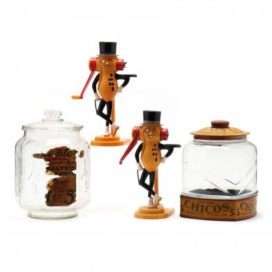 a-group-of-four-vintage-peanut-dispensers-and-jars