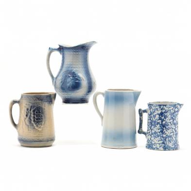 a-group-of-four-blue-stoneware-pitchers