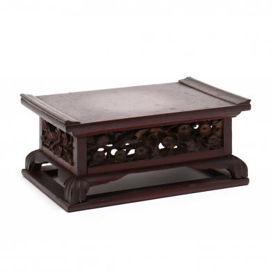 a-carved-rectangular-wooden-stand-with-birds-and-flowers