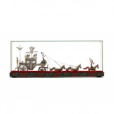 a-vintage-silver-carriage-in-a-glass-presentation-case