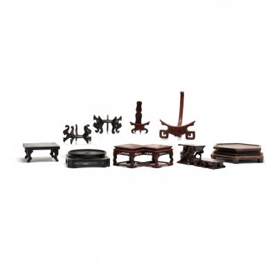 a-group-of-9-chinese-carved-wooden-stands-and-plate-holders
