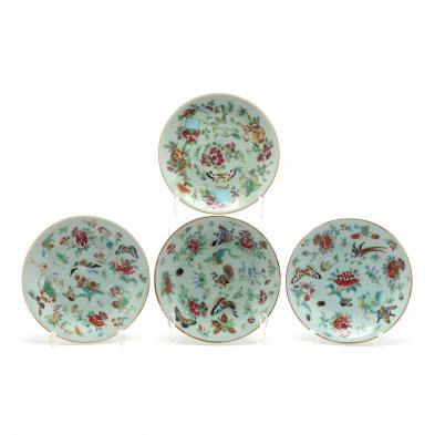 a-group-of-four-chinese-celadon-plates-with-butterflies-and-flora