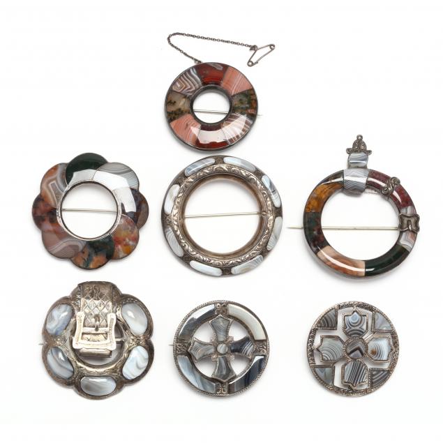 group-of-silver-and-gem-set-brooches