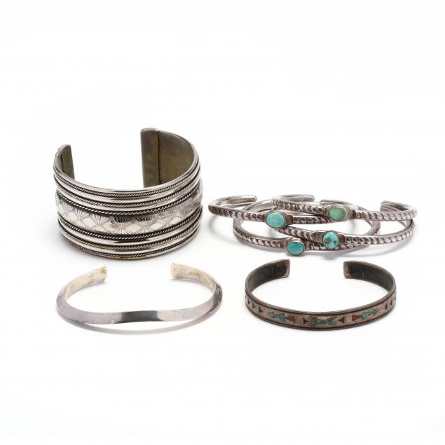 group-of-mostly-silver-cuff-bracelets