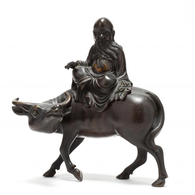 an-asian-bronze-sculpture-of-man-riding-ox