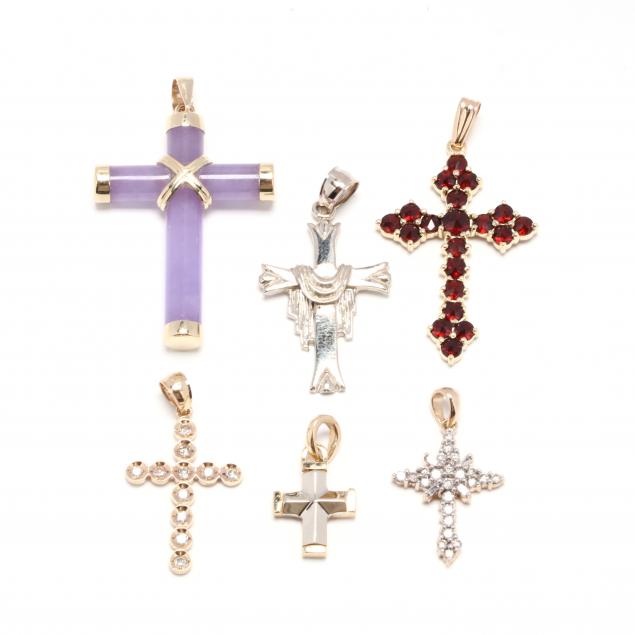 a-group-of-gold-and-gemstone-cross-pendants
